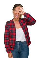 Sticker - Middle age adult woman wearing casual jacket over isolated background doing ok gesture with hand smiling, eye looking through fingers with happy face.