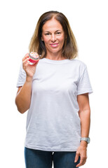 Wall Mural - middle age hispanic woman eating cupcake over isolated background with a confident expression on sma
