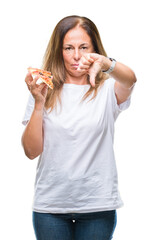 Sticker - Middle age hispanic woman eating pizza slice over isolated background with angry face, negative sign showing dislike with thumbs down, rejection concept