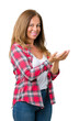 © Krakenimages.com - Beautiful middle age woman wearing over isolated background Pointing to the side with hand and open palm, presenting ad smiling happy and confident