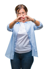 Wall Mural - Middle age senior hispanic woman over isolated background smiling in love showing heart symbol and shape with hands. Romantic concept.