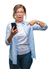 Wall Mural - middle age senior woman texting sending message using smartphone over isolated background with surpr