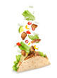 Delicious taco with flying ingredients on white background