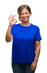 Sticker - Middle age senior hispanic woman over isolated background smiling positive doing ok sign with hand and fingers. Successful expression.