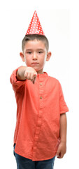 Canvas Print - Dark haired little child wearing birthday cap pointing with finger to the camera and to you, hand sign, positive and confident gesture from the front