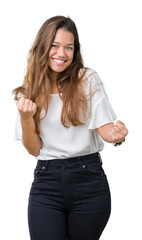 Sticker - Young beautiful brunette business woman over isolated background very happy and excited doing winner gesture with arms raised, smiling and screaming for success. Celebration concept.