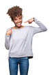 © Krakenimages.com - Beautiful young african american woman over isolated background smiling confident showing and pointing with fingers teeth and mouth. Health concept.