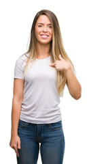 Sticker - Beautiful young woman wearing t-shirt and jeans with surprise face pointing finger to himself