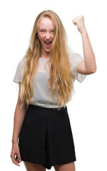 Canvas Print - Blonde teenager woman wearing moles shirt angry and mad raising fist frustrated and furious while shouting with anger. Rage and aggressive concept.