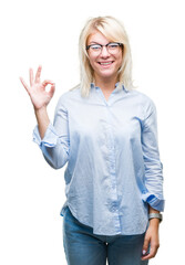 Poster - Young beautiful blonde business woman wearing glasses over isolated background smiling positive doing ok sign with hand and fingers. Successful expression.