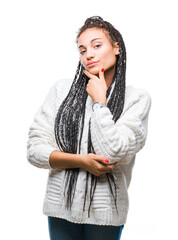 Poster - Young braided hair african american girl wearing sweater over isolated background looking confident at the camera with smile with crossed arms and hand raised on chin. Thinking positive.