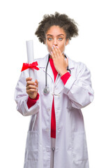 Canvas Print - Young afro american doctor woman holding degree over isolated background cover mouth with hand shocked with shame for mistake, expression of fear, scared in silence, secret concept