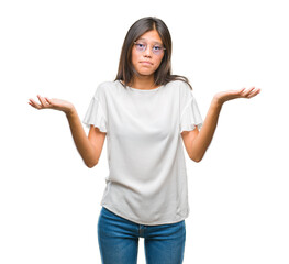 Wall Mural - Young asian woman wearing glasses over isolated background clueless and confused expression with arms and hands raised. Doubt concept.