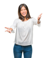 Sticker - Young asian woman over isolated background looking at the camera smiling with open arms for hug. Cheerful expression embracing happiness.