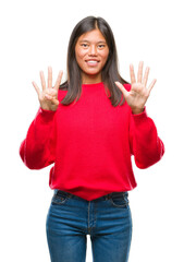 Sticker - Young asian woman wearing winter sweater over isolated background showing and pointing up with fingers number nine while smiling confident and happy.