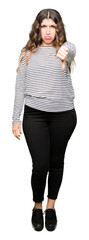 Sticker - Young beautiful woman wearing stripes sweater looking unhappy and angry showing rejection and negative with thumbs down gesture. Bad expression.