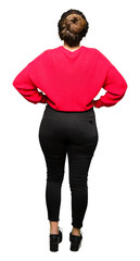 Sticker - Young beautiful woman wearing red sweater and bun standing backwards looking away with arms on body