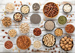 Mixed assorted raw healthy nuts and seeds in various bowls on light wooden table.Peanut,hazelnut,walnut,almonds,pistachio,sunflower,pumpkin,chia and cashew.Top view.