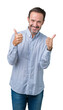 © Krakenimages.com - Handsome middle age elegant senior man over isolated background success sign doing positive gesture with hand, thumbs up smiling and happy. Looking at the camera with cheerful expression.
