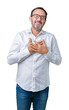 © Krakenimages.com - Handsome middle age elegant senior business man wearing glasses over isolated background smiling with hands on chest with closed eyes and grateful gesture on face. Health concept.