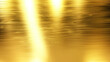 A gold-colored surface with ripples and waves. The surface is shiny and reflective. Concept of luxury and opulence