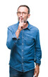© Krakenimages.com - Middle age hoary senior man wearing glasses over isolated background asking to be quiet with finger on lips. Silence and secret concept.