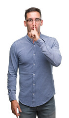 Poster - Handsome young elegant man wearing glasses asking to be quiet with finger on lips. Silence and secret concept.