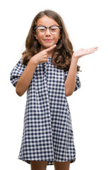 Poster - Brunette hispanic girl wearing glasses very happy pointing with hand and finger