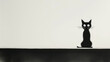  A black cat perched on a contrasting black-and-white wall beside a black-and-white feline portrait