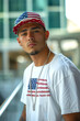 © Gesfera Images - A man wearing a red, white and blue hat and a white shirt with an American flag on it