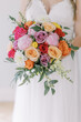 Bridal bouquet with vibrant roses and greenery