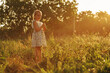 Little girl with dandelions at the countryside