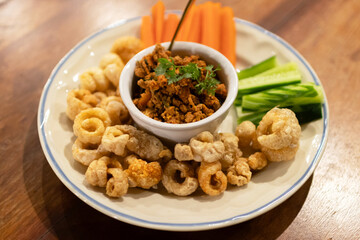 Wall Mural - Nam Prik Ong (Spicy Northern Thai Pork and Tomato) with deep-fried skin pork and vegetable.