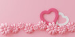 A pink background with a heart and a flower on it