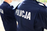 Fototapeta  - Napis policja na niebieskim mundurze.