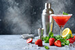 Cold summer strawberry cocktail with lemon and basil in a  martini  glasses .