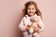 AI generated illustration of a happy little girl holding a teddy bear and smiling for the camera