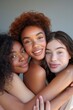 © Svetlana - Three young women of different races and nationalities hug each other, they all smile happily. A portrait photo for a magazine cover with light background, studio lighting, closeup faces of the women