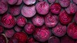 Intricate pattern of halved and whole blood beetroots, highlighting the contrast in textures