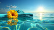 A yellow flower is floating on top of a blue towel in the ocean. The scene is serene and peaceful, with the sun shining brightly in the background