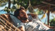 © Borin - A man feeling relaxed and carefree as he lounges on a hammock.