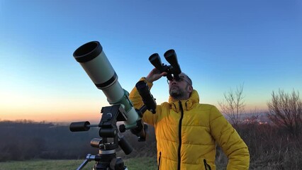 Wall Mural - Amateur astronomer observing skies with telescope and binoculars.	
