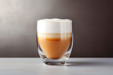 A latte in a clear glass, the elegance of the drink accentuated by the simplicity of its presentation, isolated on a minimalist chic background, symbolizing the modern cafe culture's sophistication