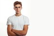 © Nikolay - A young man in a white t shirt on a white background.