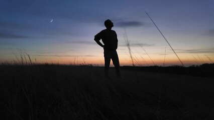 Wall Mural - man looking at night skies, observing celestial objects, moon, planets, meteors.