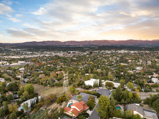 Wall Mural - Aerial view of a small town and valley at sunset in Encino, California