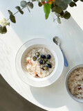 Fototapeta Desenie - Vegan Rice porridge breakfast bowl with blueberries and raisins. Top view
