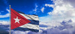 Cuba national flag cloth fabric waving on beautiful Blue Sky Background.