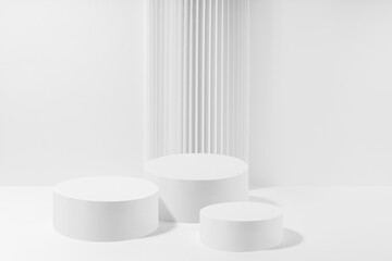 Wall Mural - Three white round podiums with striped column as geometric decor, set, mockup on white background. Template for presentation cosmetic products, gifts, goods, advertising, design in modern style.