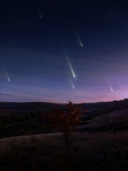 Wall Mural - falling meteors, evening landscape. meteor shower over the hills. bright fireballs in the sky, dream